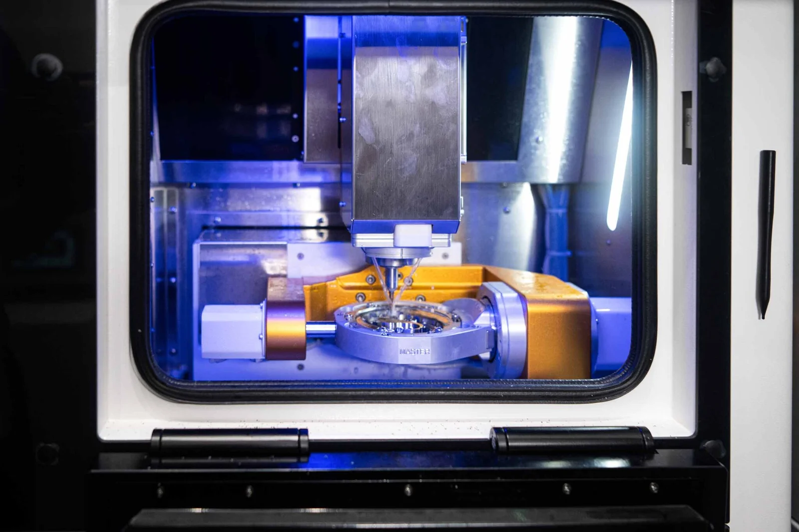 In-house CAD/CAM milling unit cutting a zirconia crown