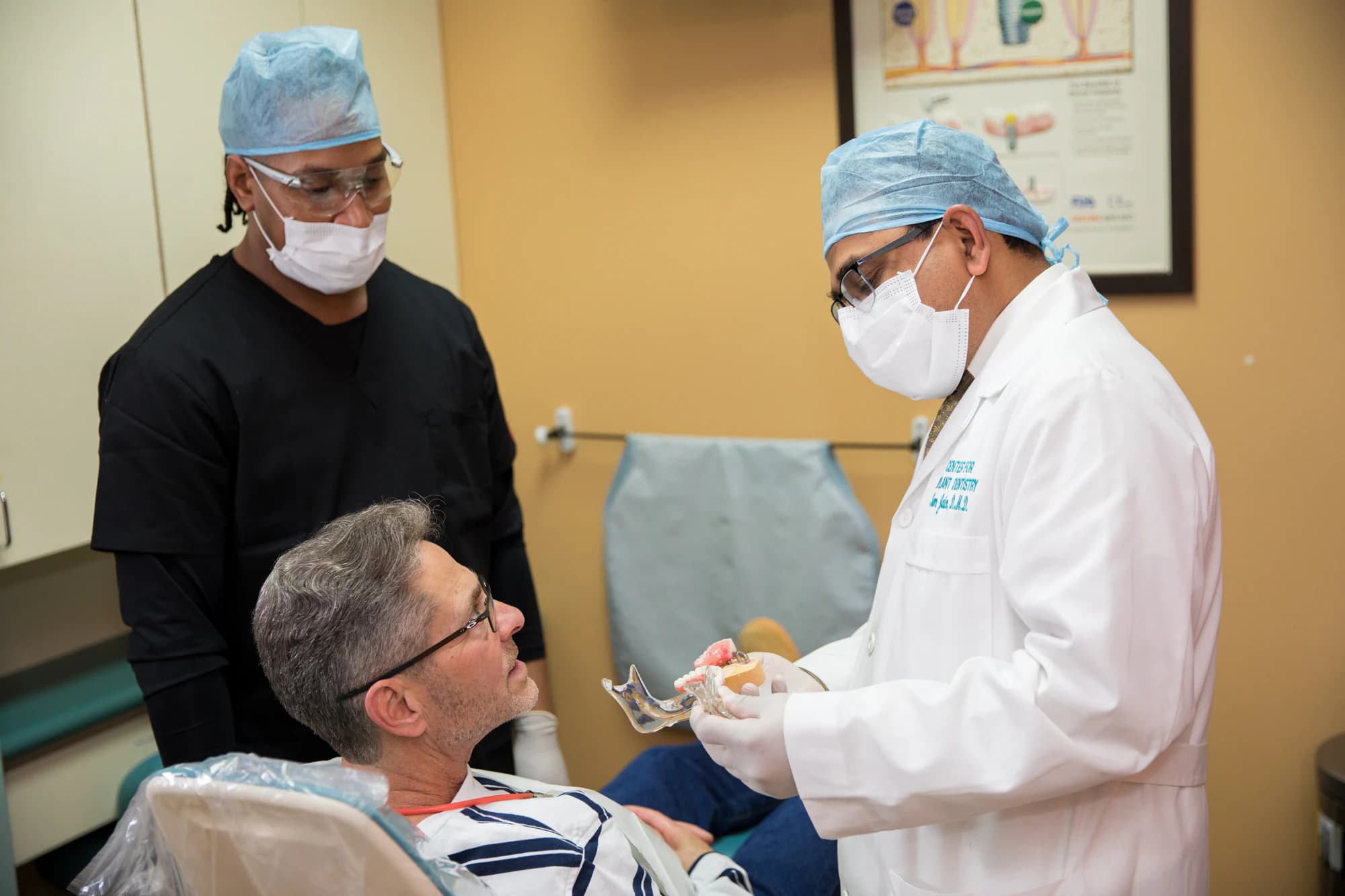Dr. Jain going through a treatment plan with a patient at the chair