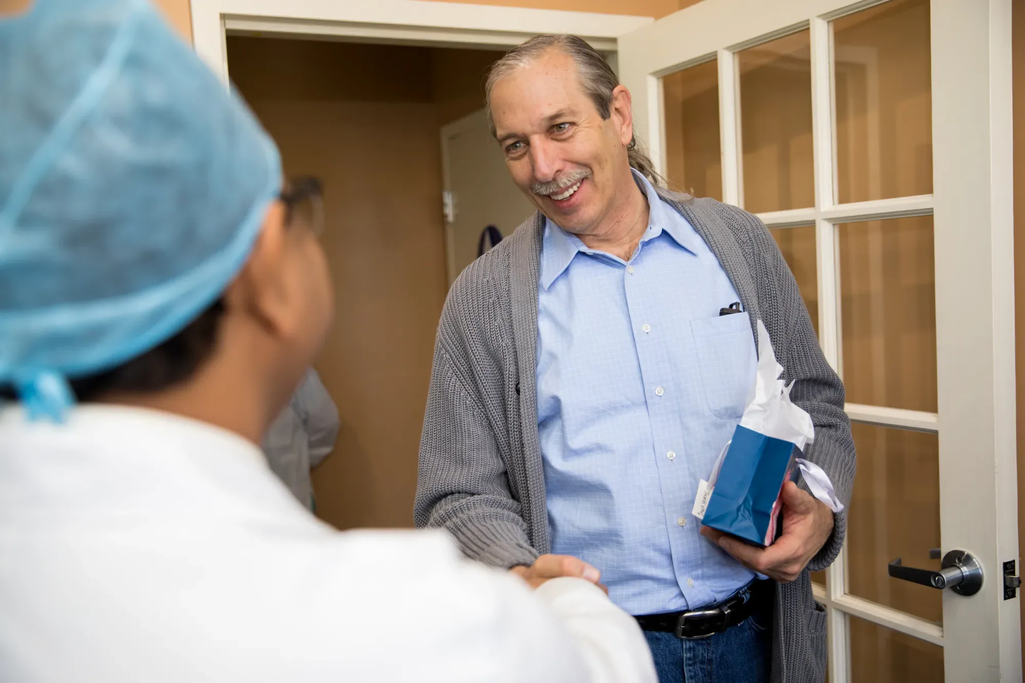 Dr. Jain reviewing a smile design with a patient chairside