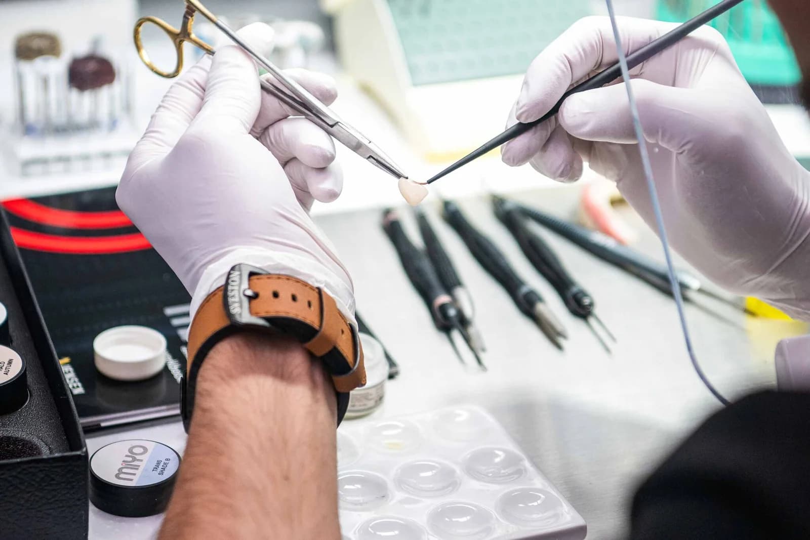 Prosthetic teeth being finished and polished in the on-site lab