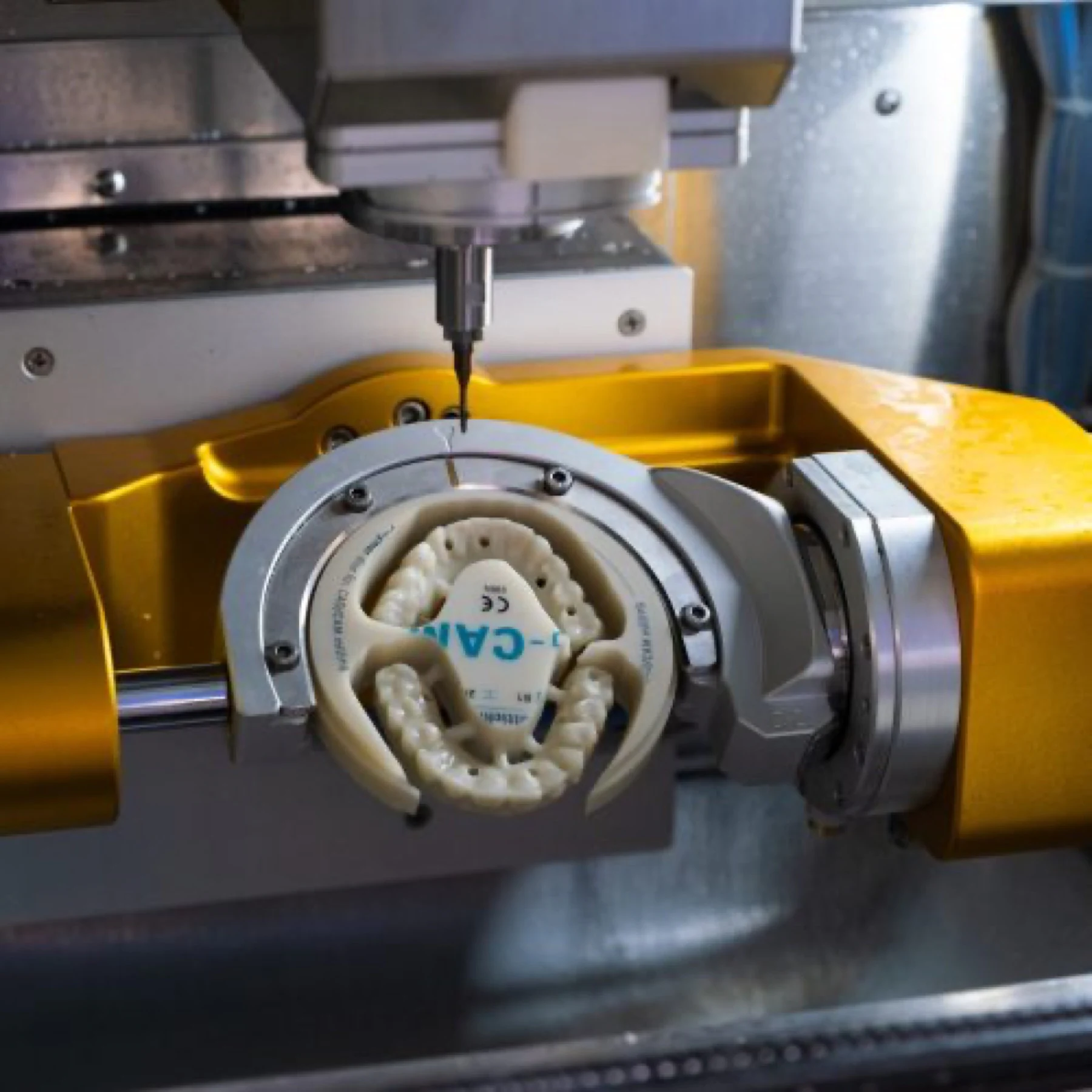 A full arch being milled from a zirconia disc in the on-site lab