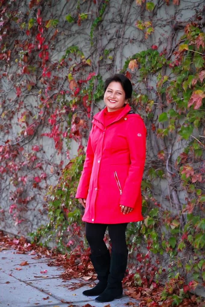 Jyoti Jain outdoors in a red coat