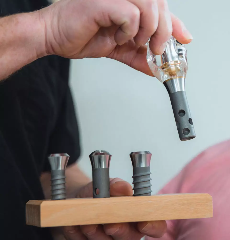 Model showing a single dental implant and crown