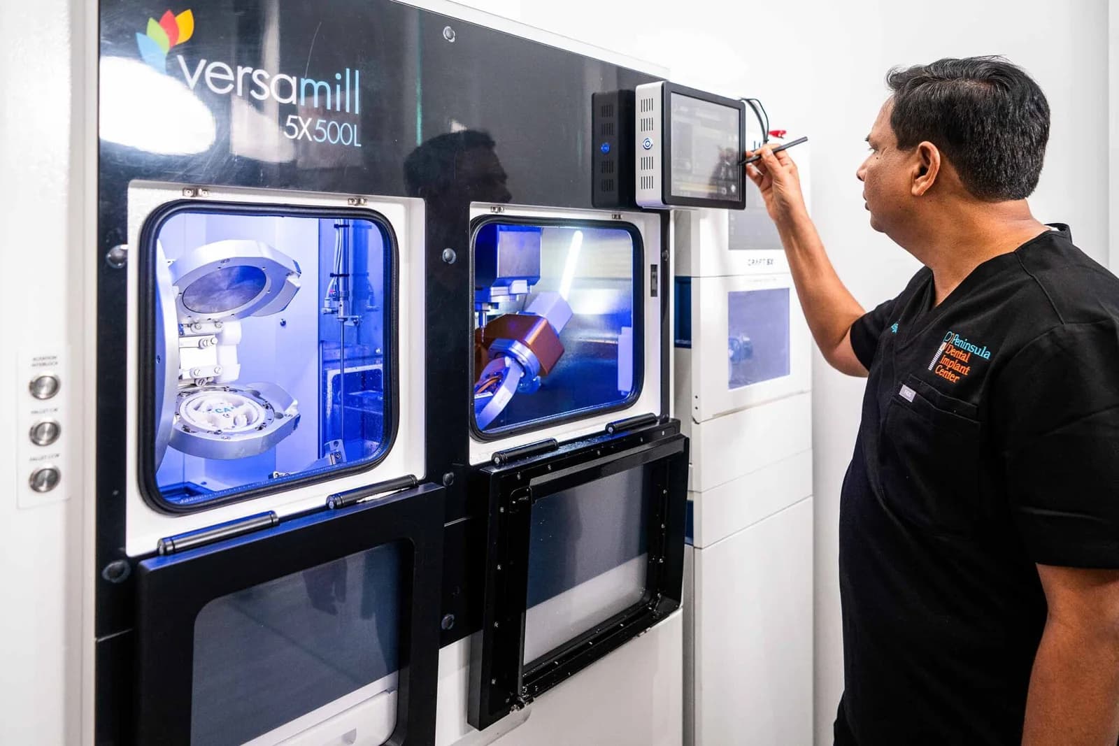 Dr. Sam Jain at the controls of the five-axis mill that cuts the practice's zirconia