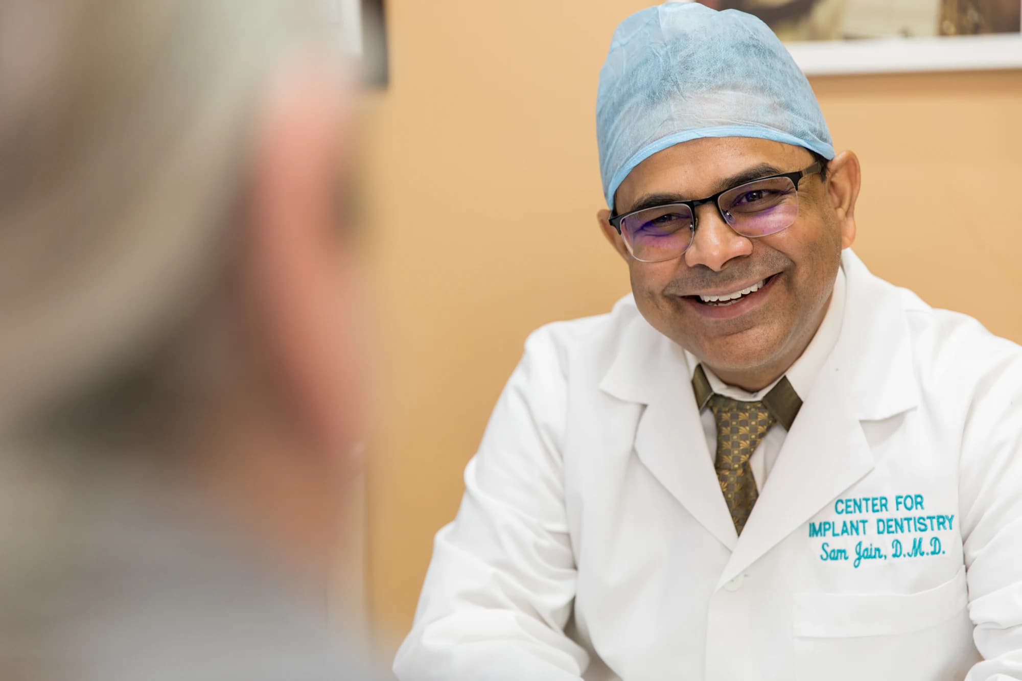 Dr. Sam Jain during a consultation