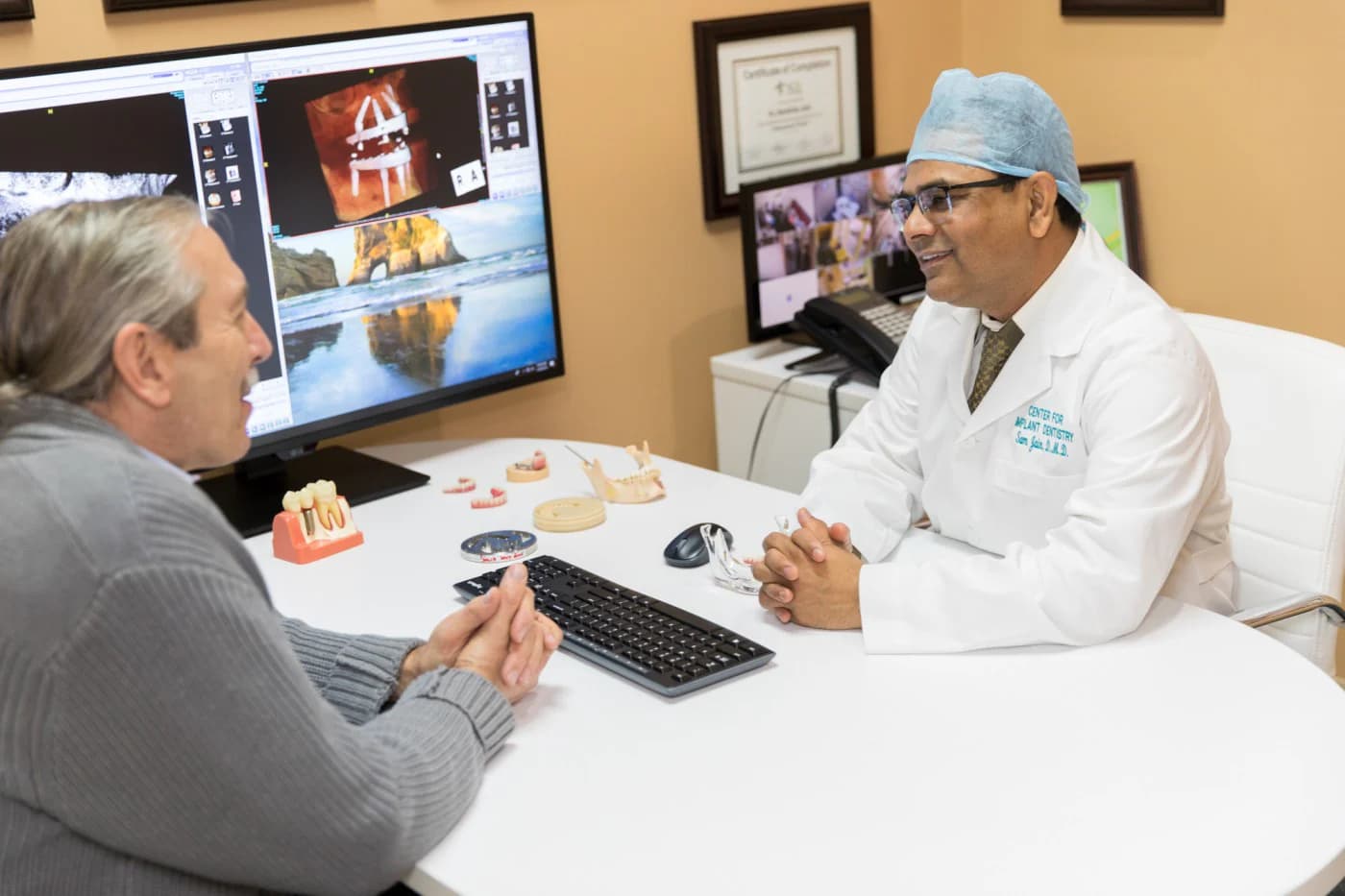 Dr. Sambhav Jain reviewing an implant scan with a patient