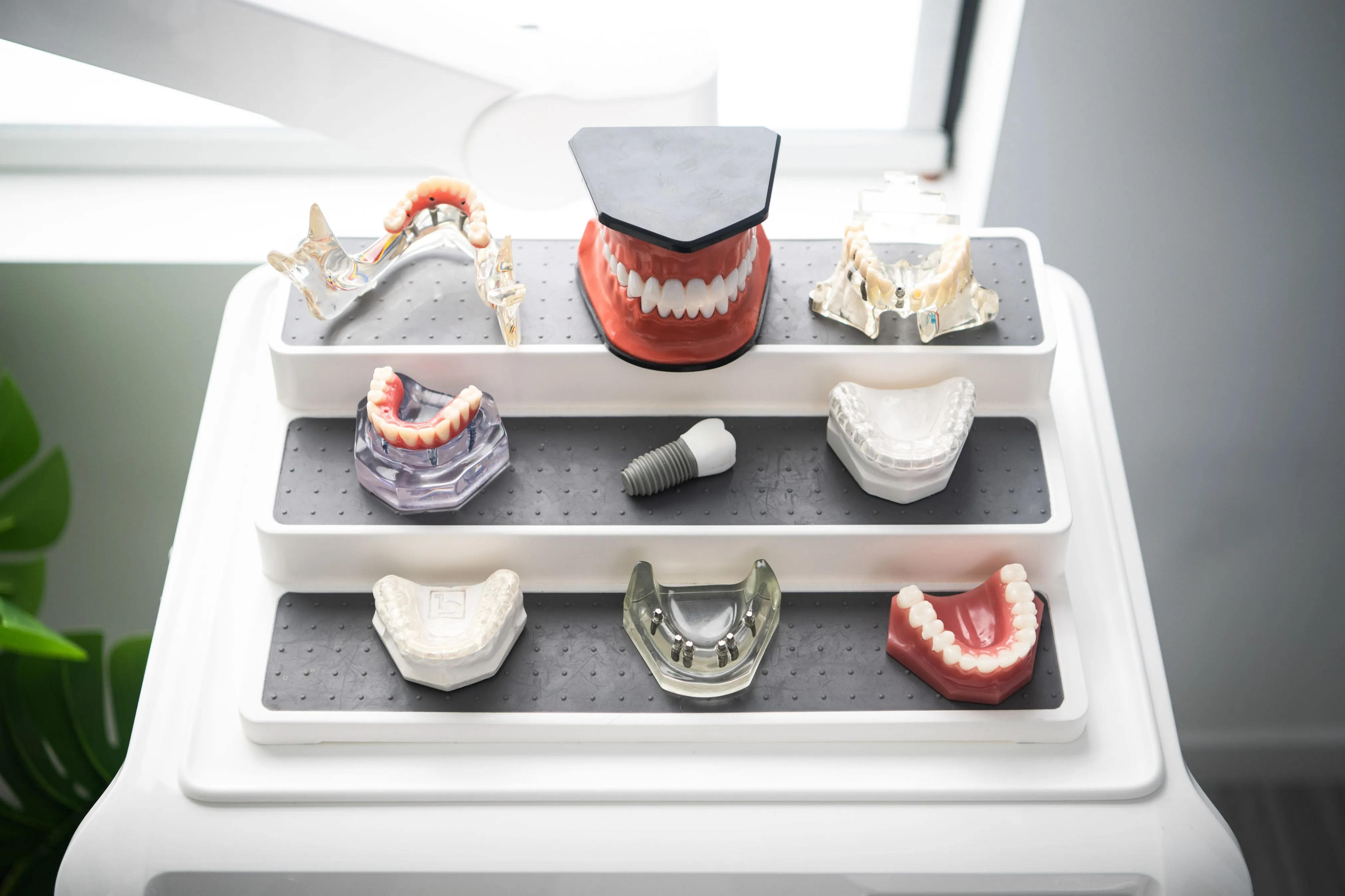 Finished implant restorations displayed on a tray