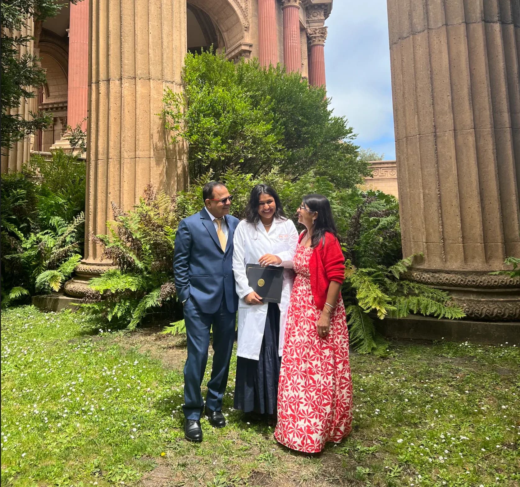 Gauri Jain in her dental-school white coat with her family