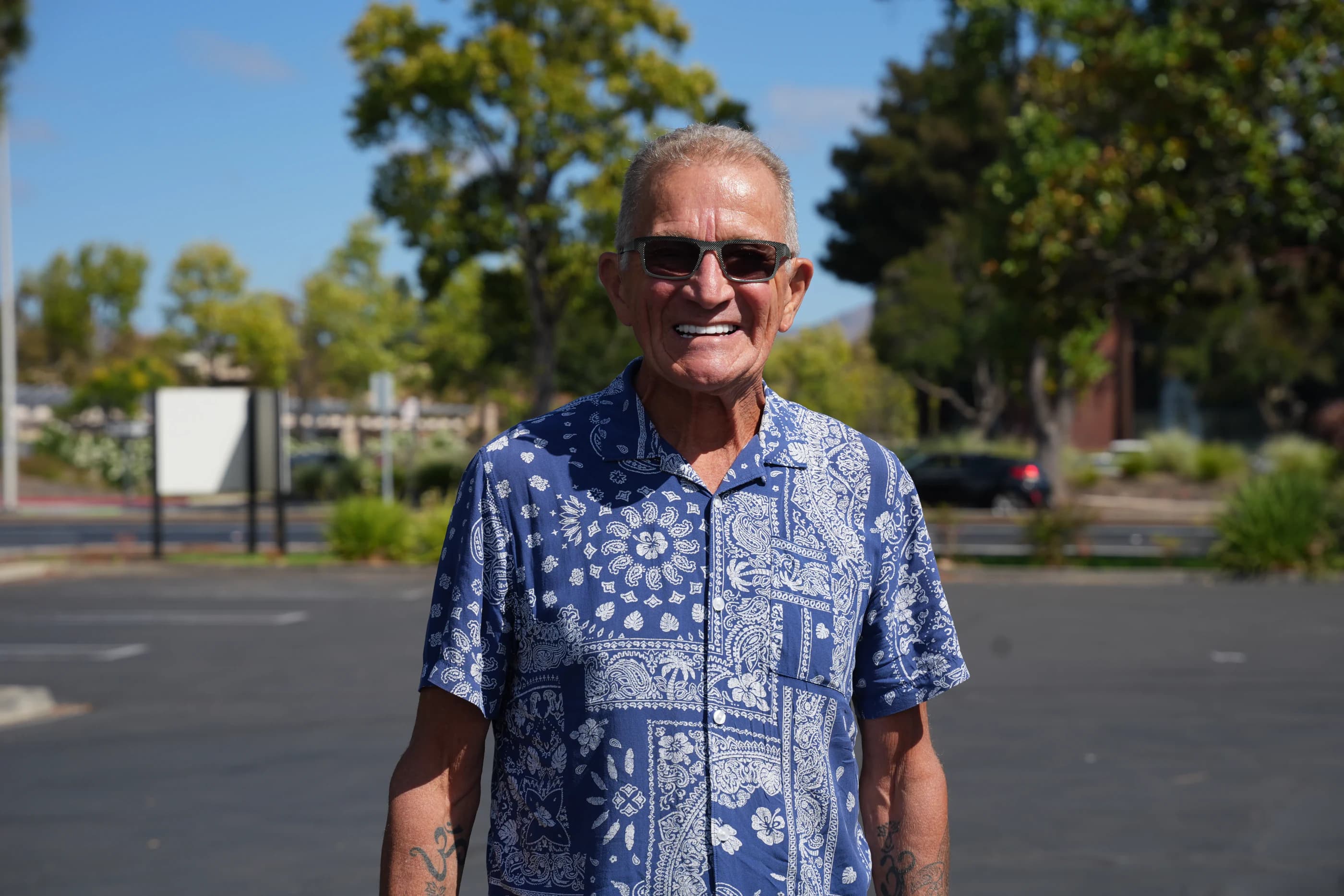 A smiling patient standing outdoors