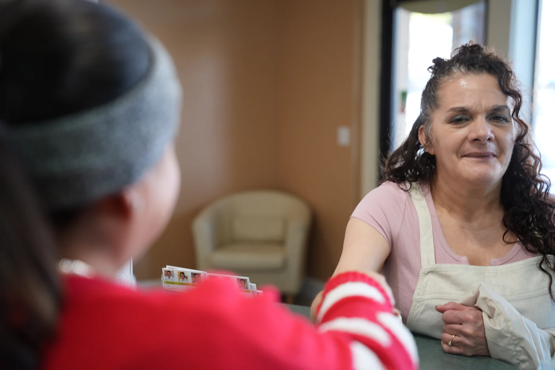 A patient going over her paperwork at the front desk