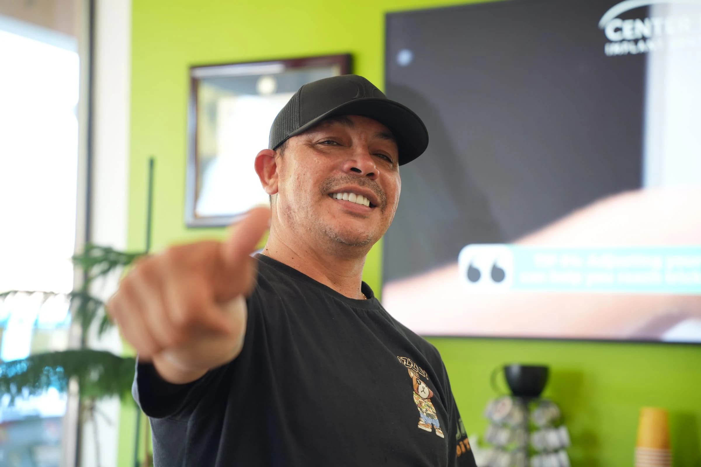 A patient pointing at the camera on his way out