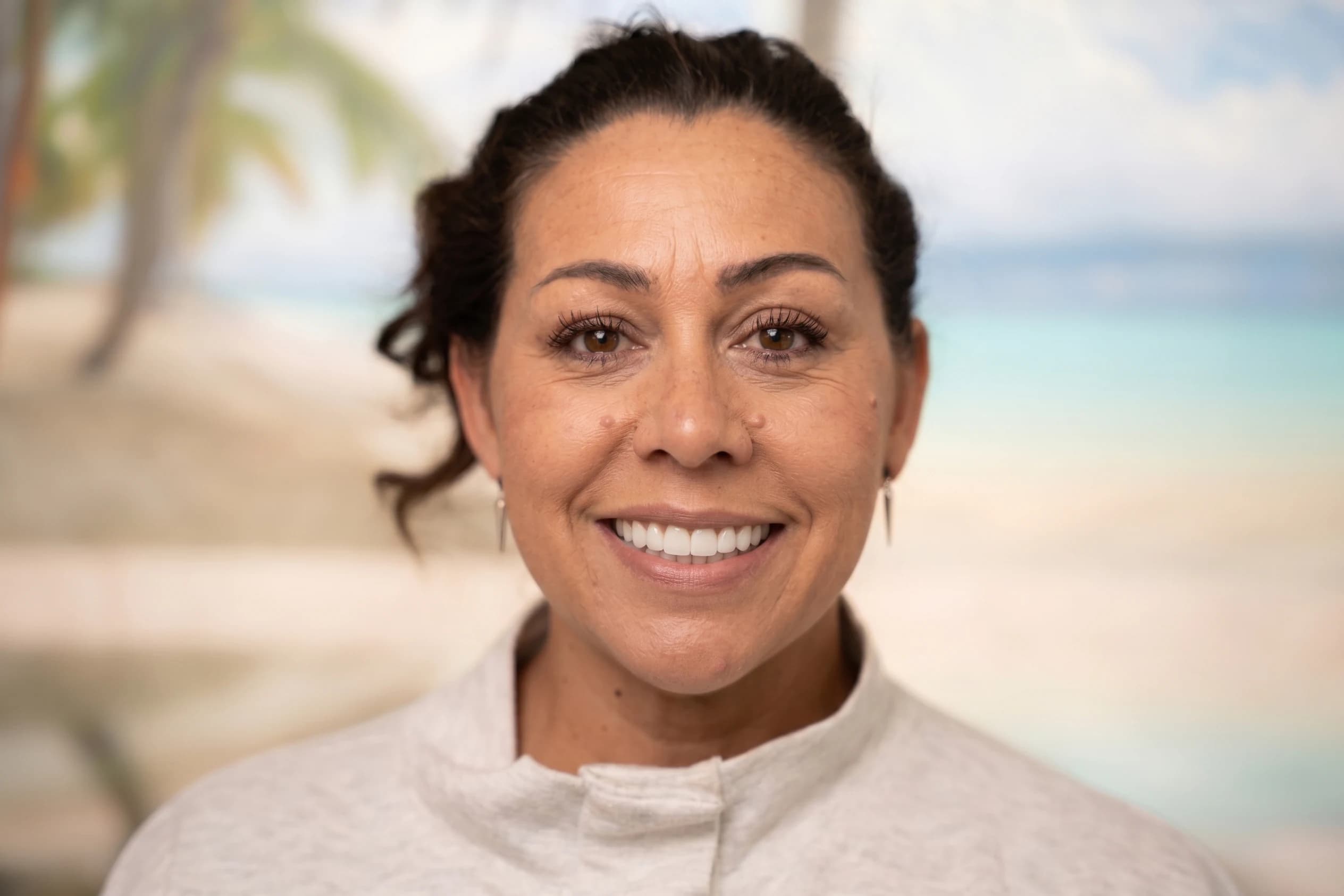 A smiling implant patient in the treatment room
