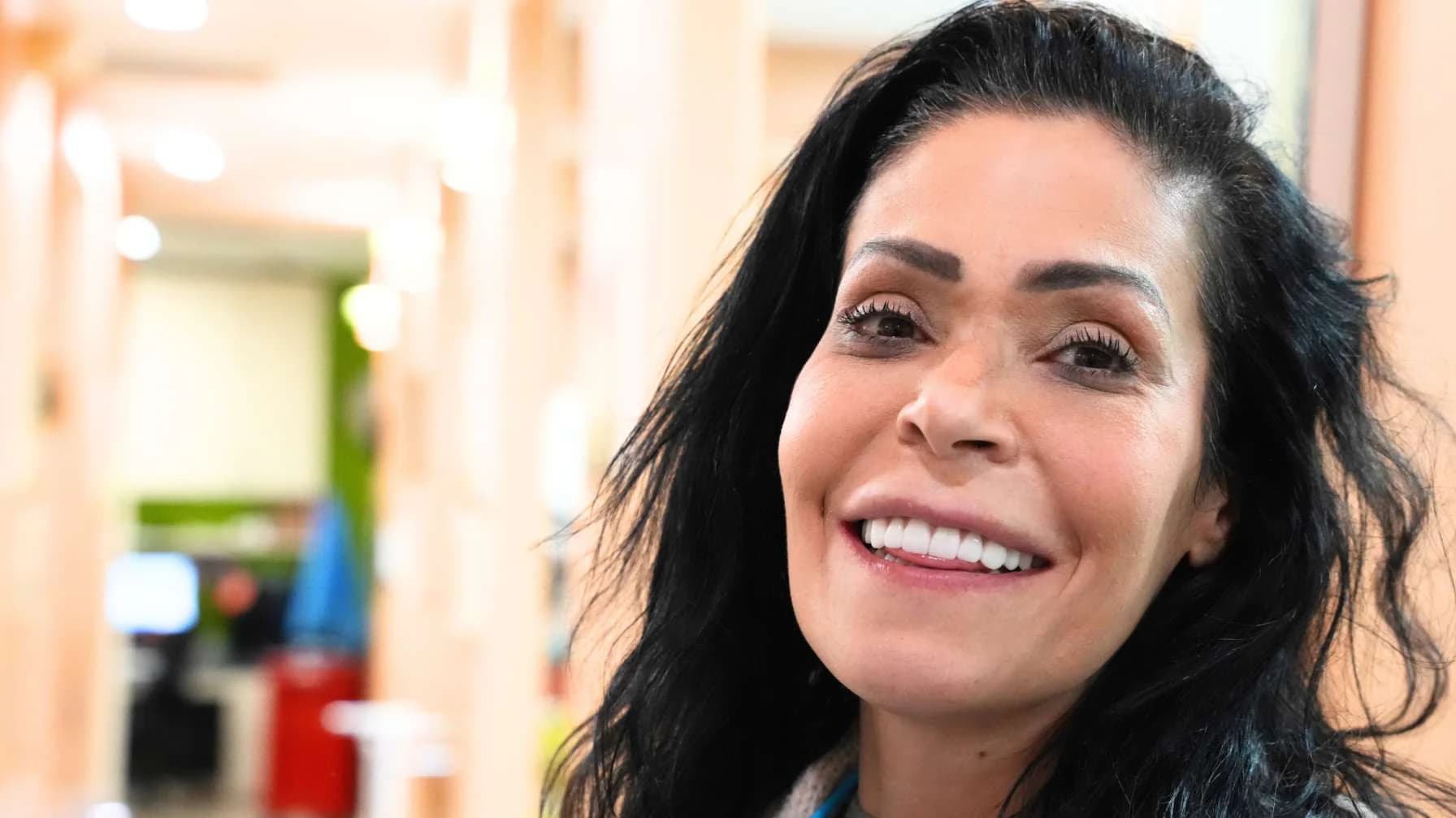A patient smiling in the office after her treatment