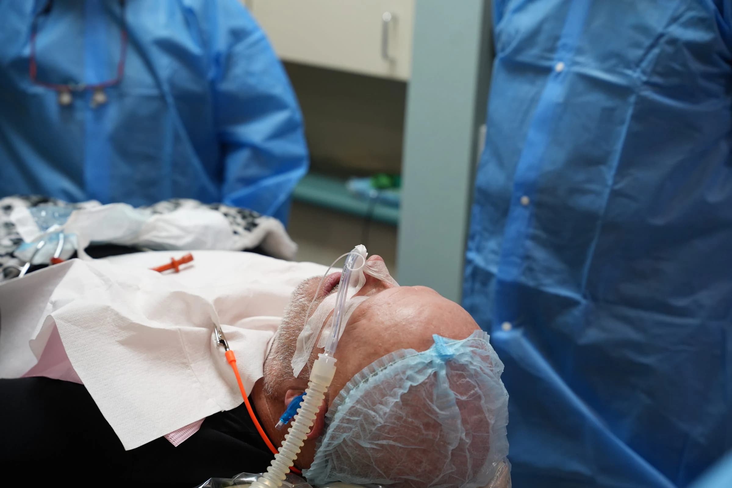 A monitored patient resting under intravenous sedation