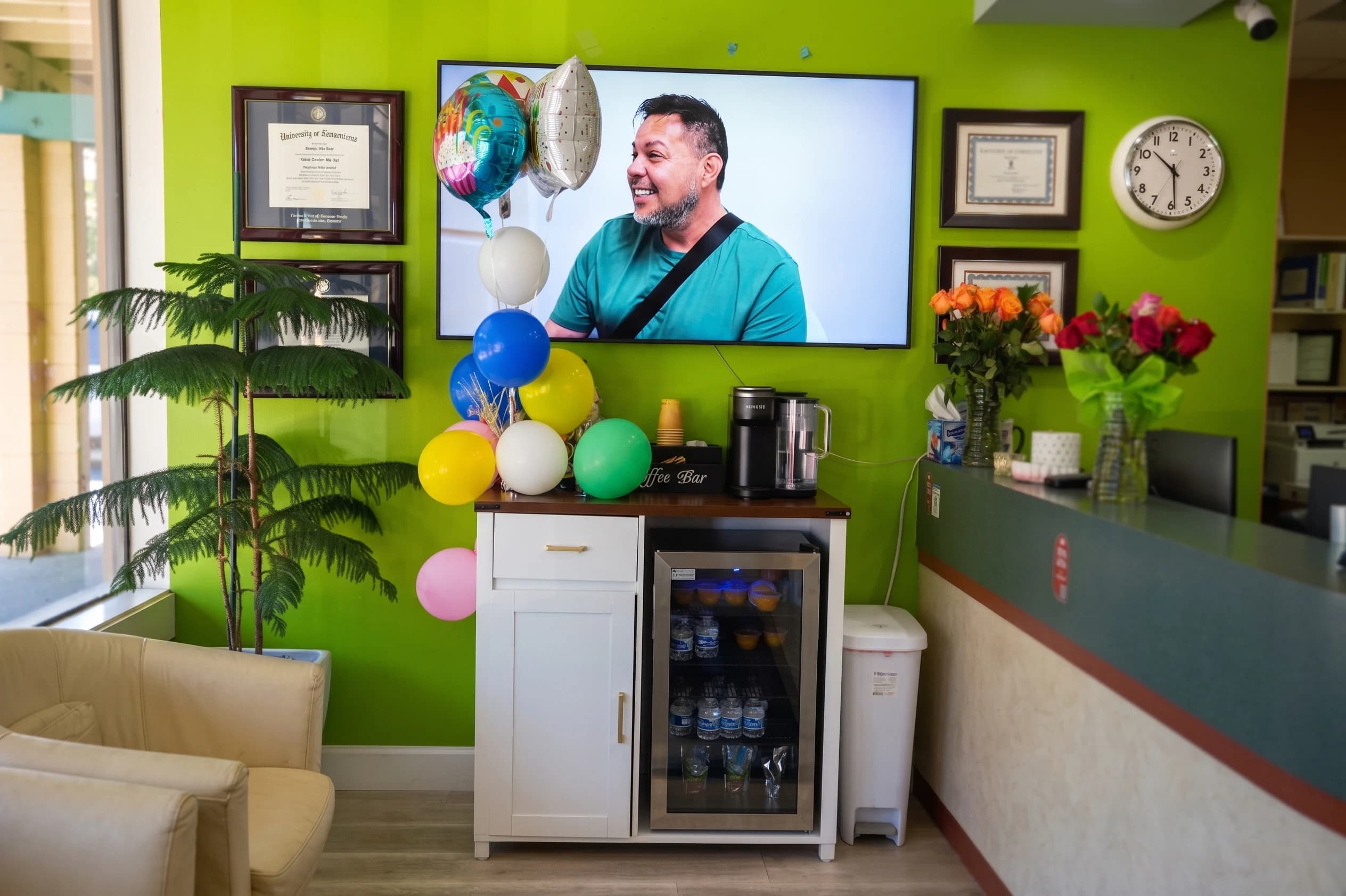 The waiting area, with patient video stories playing on the wall screen
