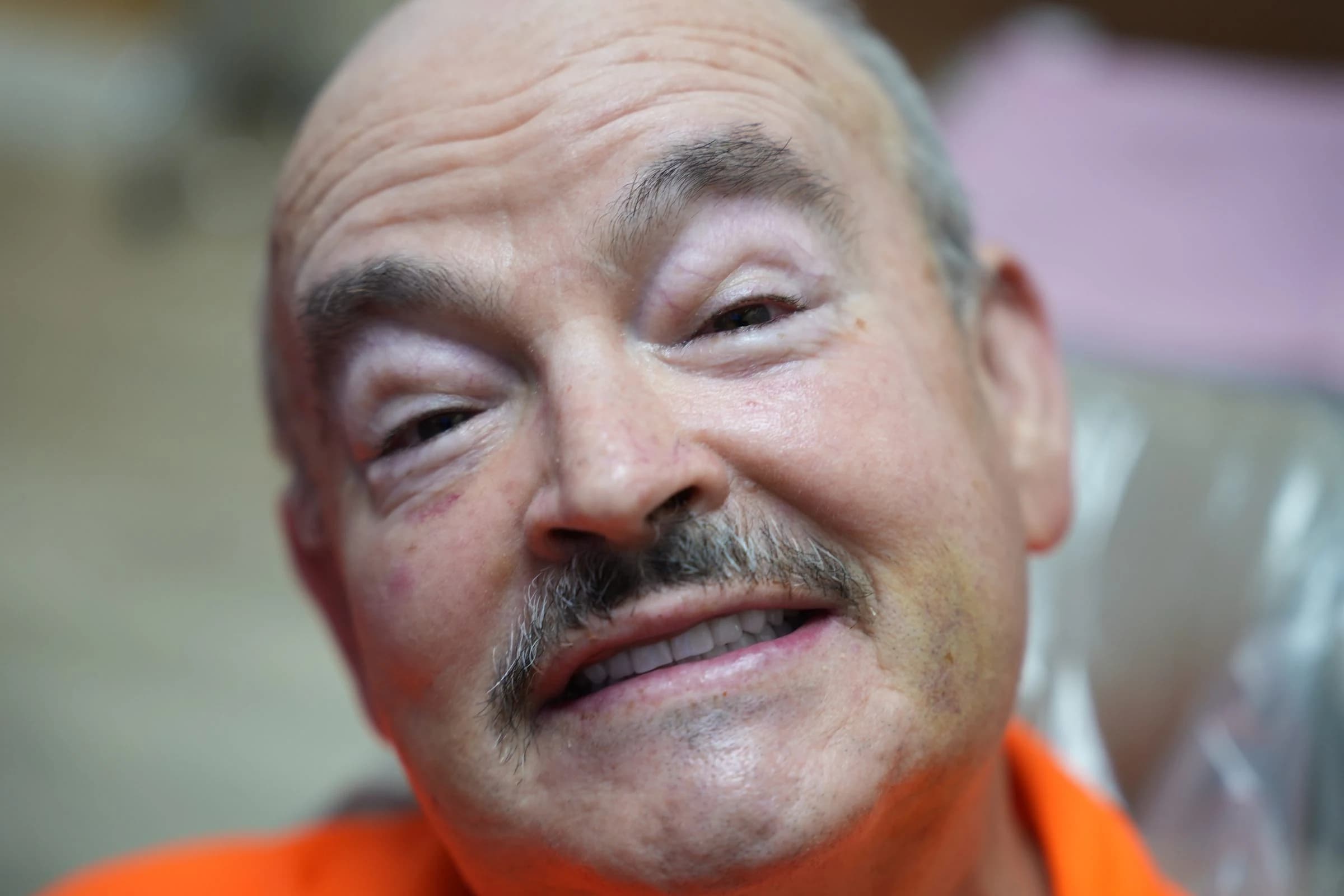 A senior implant patient smiling in the chair