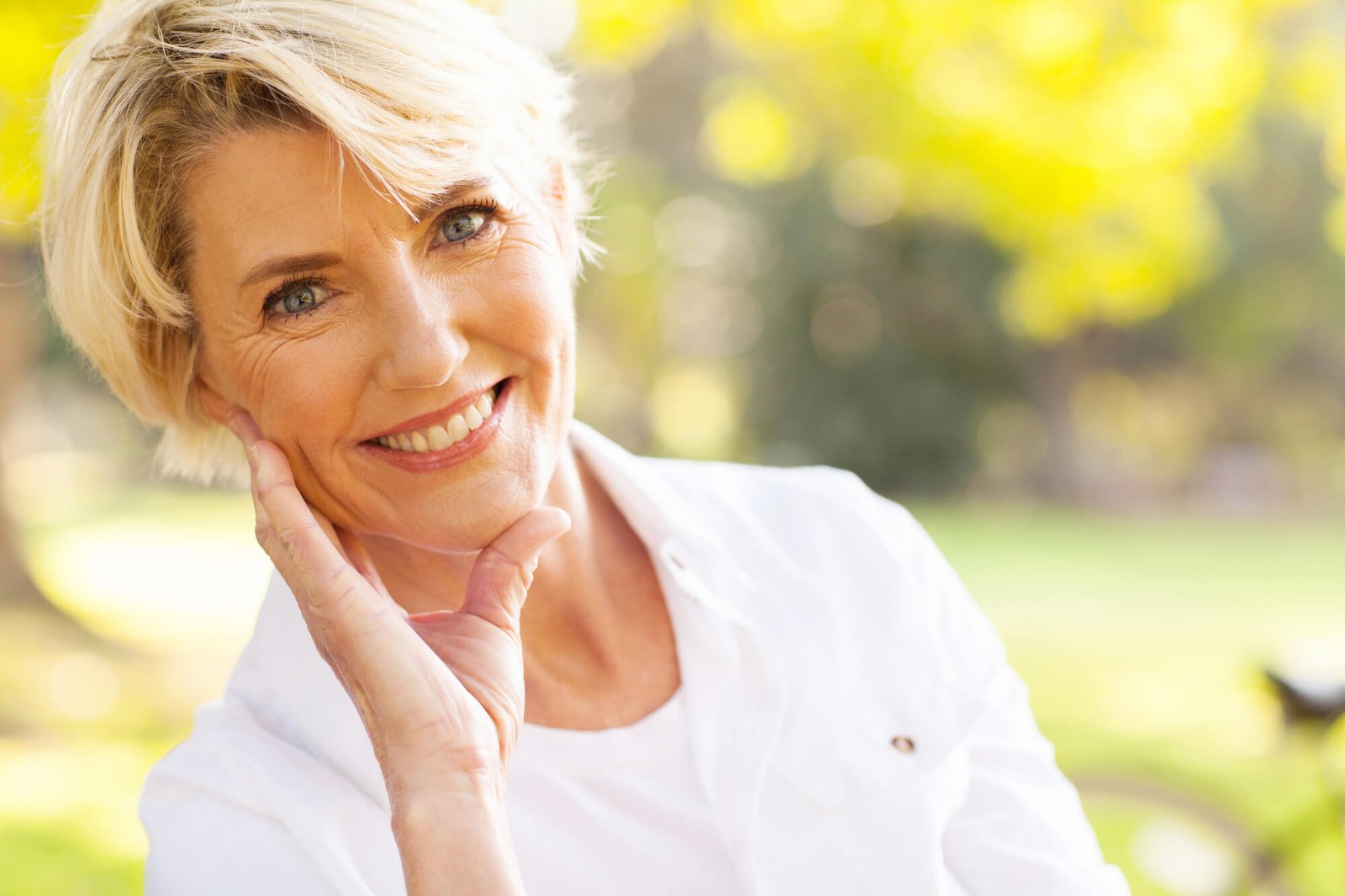 a senior woman smiling after seeing an Implant Dentist in Fremont CA